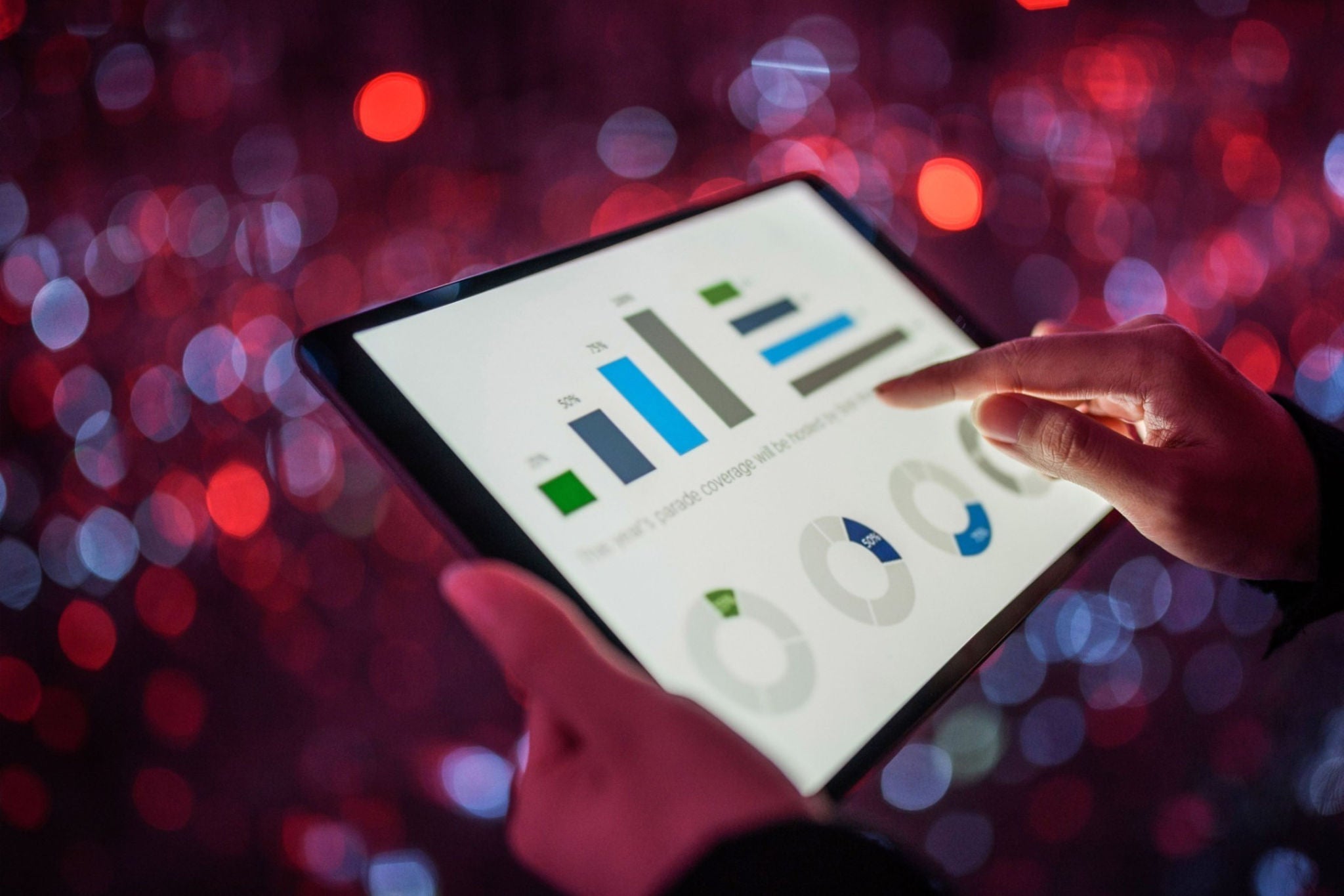 analyzing financial data on tablet with graphs